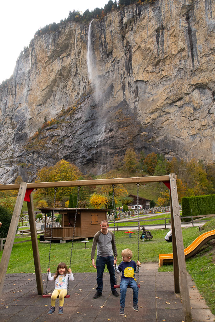 Kids playing in park by Staubbach waterfall in Lauterbrunnen, Switzerland.
